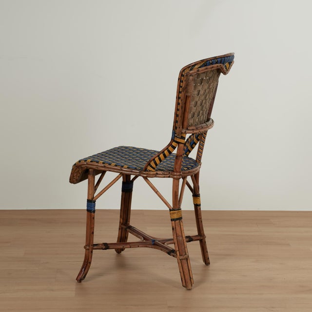 Set of eight vintage French bistro chairs crafted in rattan in classic form with woven reed seats and backs paint...