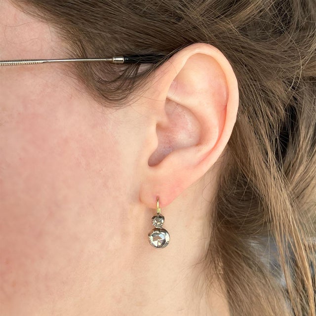 The soft flicker of candlelight catches the facets, reflecting a glow that once illuminated grand ballrooms and whispered...