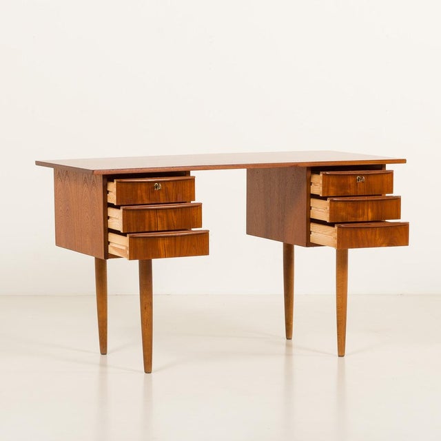This small Danish mid-century teak desk comes from the 1960s and is a great example of Scandinavian craftsmanship and...
