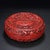 This is a substantial and intricately crafted carved lacquer box, featuring deep, detailed relief work in a rich,...