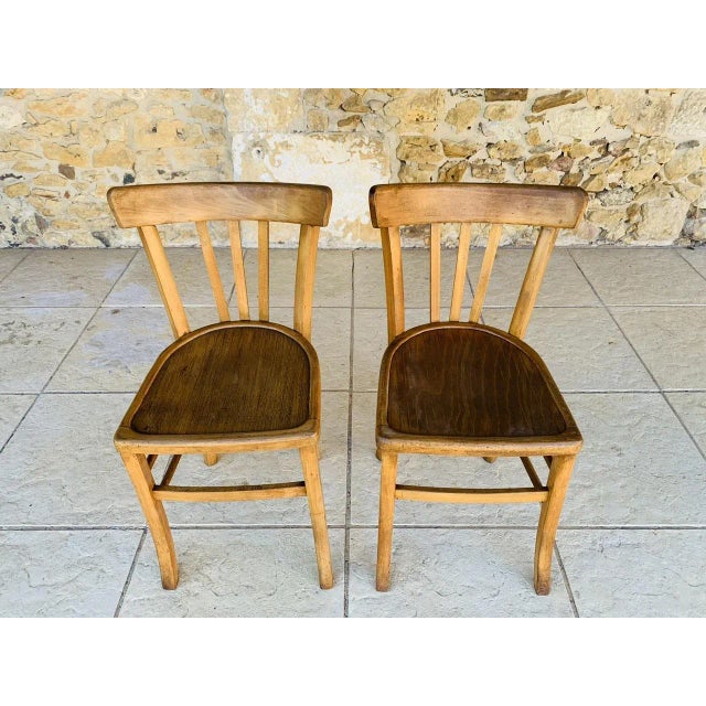 Vintage bistro chairs, set of 2, circa 50’s / 60’s. Pieces are made of beechwood. Pieces are in overall good, original and...