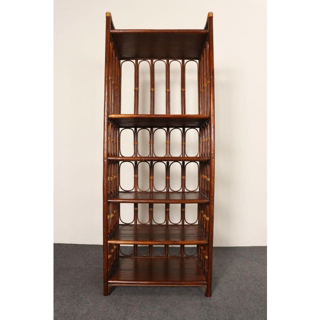 Vintage bookshelf/etagere unit with six surfaces (ca. 1970s, France). Composed of a stained bamboo frame with woven rattan...