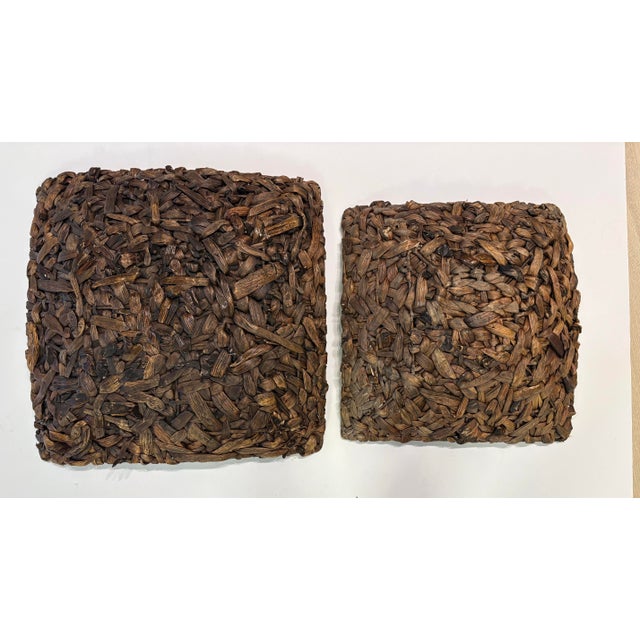 Set of two handwoven natural fiber sculptural pieces crafted from water hyacinth or seagrass. Featuring a thick,...