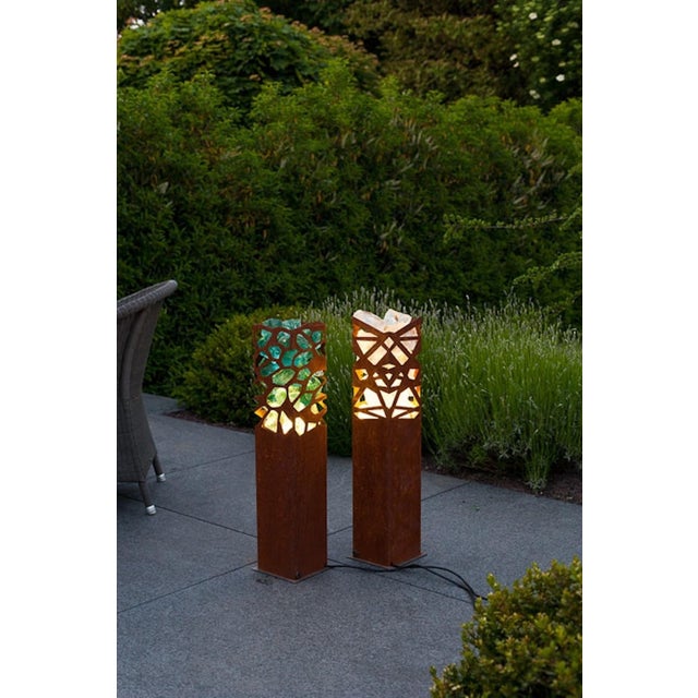 Stylish column light for outdoor use. The luminaire is filled with glass chunks and is illuminated from below with a 5...