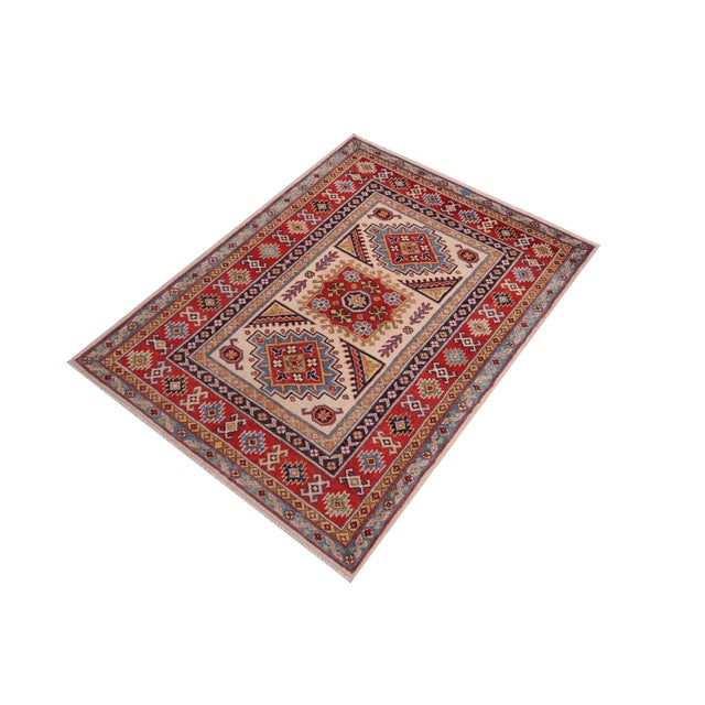 Enhance your home with this exquisite hand-knotted Kazak rug, crafted from fine hand-spun wool and dyed with all-natural...