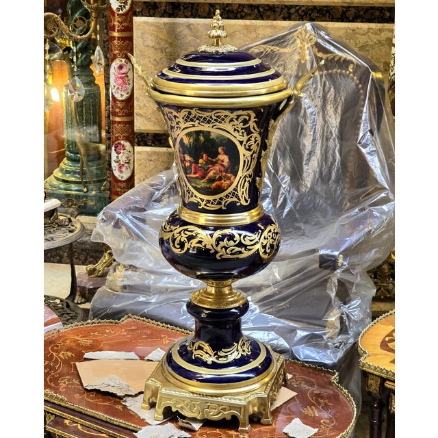 Elevate an elegant interior with this unique French-style decorative porcelain urn, featuring a striking deep navy blue...