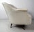 This midcentury lounge chair features a white scalloped back vinyl seat and swivel base on tapered legs which offer a...