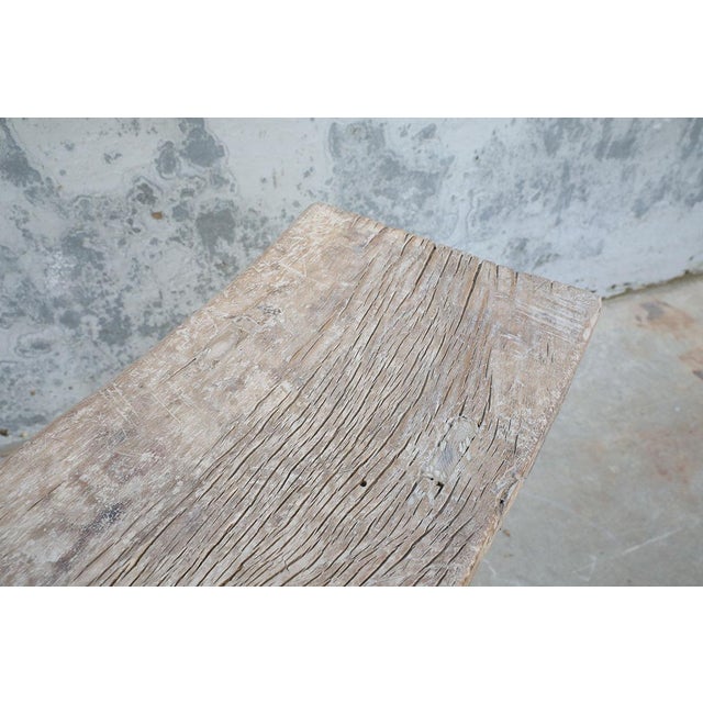 A beautifully rustic console table crafted from solid elmwood, dating to the first half of the 20th century. The long,...