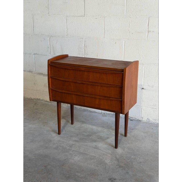 Beautiful vintage Scandinavian Modern nightstand crafted in teak in Denmark. This elegant Danish small dresser features...