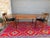 A beautifully proportioned danish modern dining table combining a sleek teak tabletop with softly rounded edges, walnut...