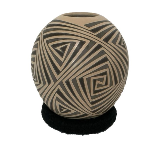 This is a hand-coiled Mata Ortiz pottery vessel featuring an intricate geometric optical-illusion maze pattern. The olla...