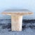 This vintage Italian side table celebrates the natural beauty of polished travertine in a striking architectural form. A...