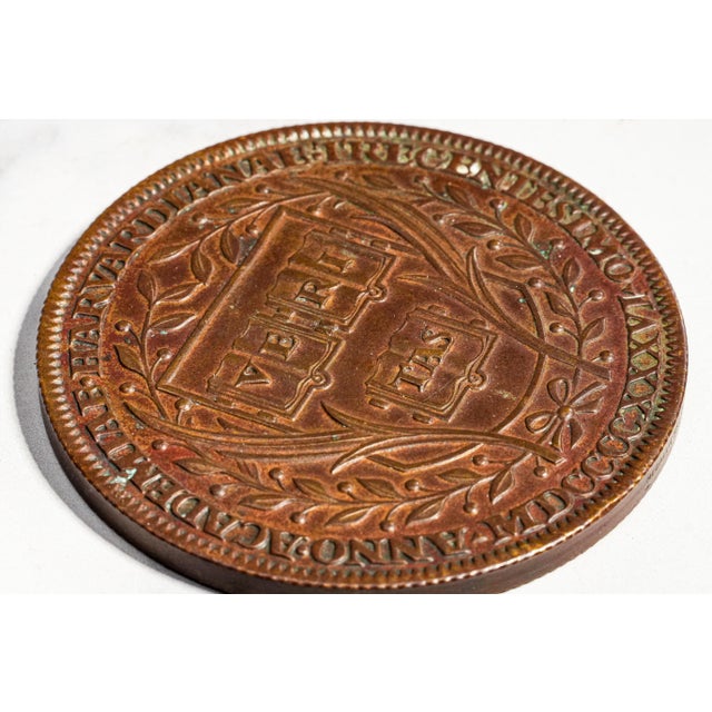 A handsome piece of Harvard history, this substantial solid metal commemorative medallion was produced in 1936 to...