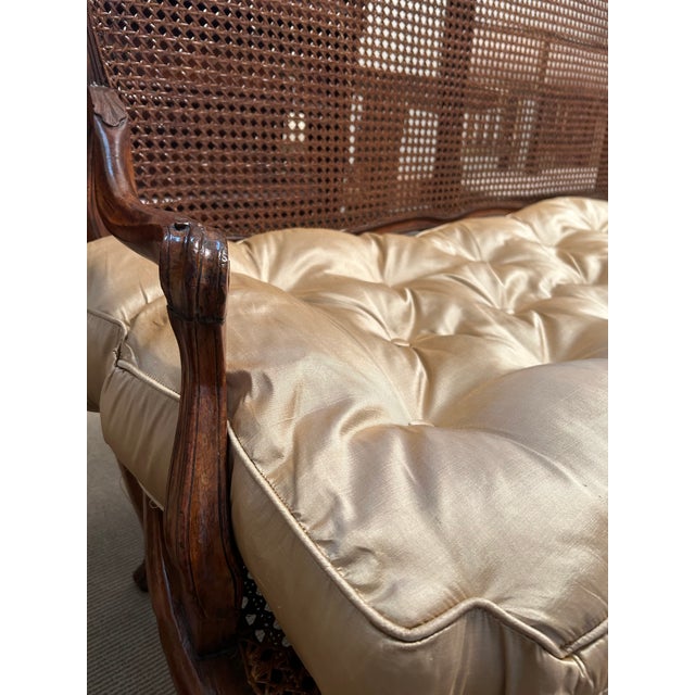 Louis XIV walnut and cane canape. Cane recently restored. New silk cushion.
