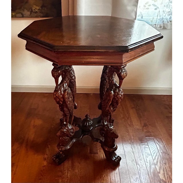 Antique 1920’s American carved mahogany, figural storks on rams heads with octagonal top, lamp / side table. Features four...