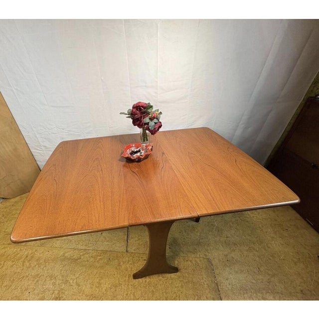 A beautifully designed mid-century teak drop leaf dining table by g plan, dating from the 1960s. This practical and...