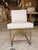 Contemporary side chair featuring clean architectural lines and a streamlined silhouette upholstered in an ivory faux...