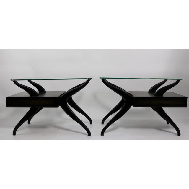 Sexy pair of mid century end, or side tables, each having a thick plate glass top, and a pull out drawer. Both are in very...