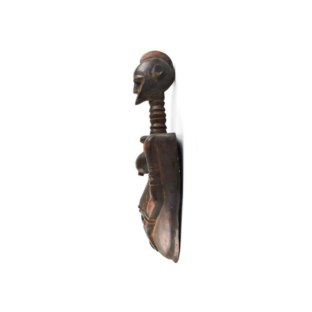 Crafted by hand from wood in Tanzania, the Nyamwezi Body Mask is a stunning and unique addition to any African art...