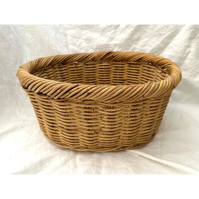 Thick Woven Rattan Oval Basket for gathering fruit, veggies or flowers. Thick twisted rattan around the top and woven...