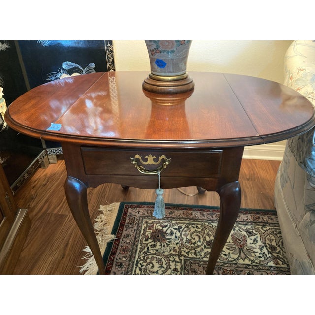 A late 20th century Drexel Heritage 18th Century collection Federal cherry wood drop leaf Pembroke style side or end table...