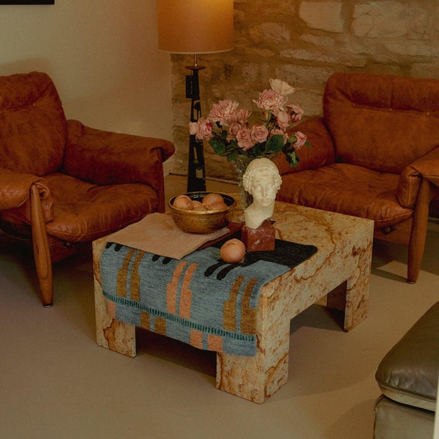 A low marble coffee table from the 1970s, shaped by the clarity and restraint of Italian modernism. The form is composed...