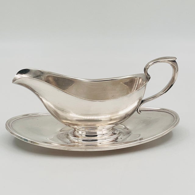 Vintage silver-plated gravy boat by the renowned Gorham Silver Company. Crafted in their timeless "Colonial" pattern, this...