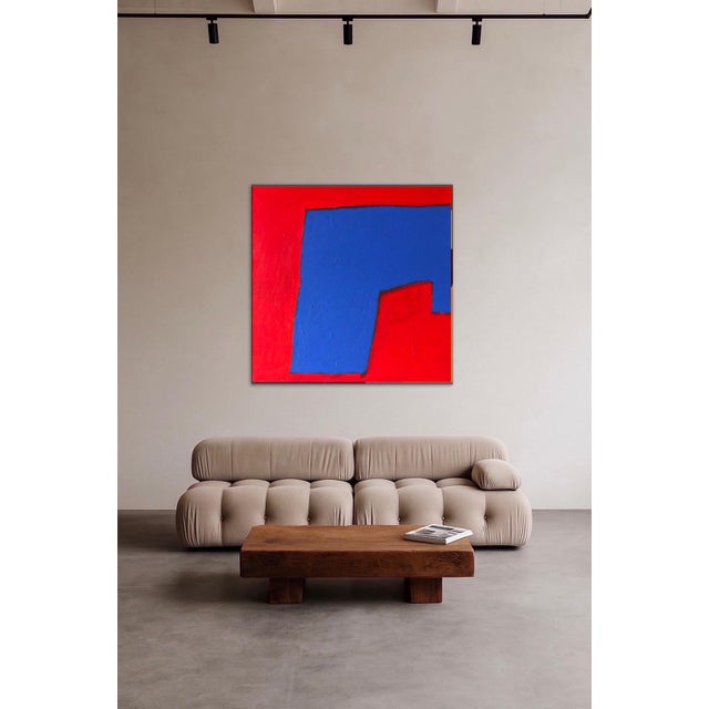 This canvas possesses an immediate presence. The interplay of vibrant red and deep blue creates a striking visual tension,...