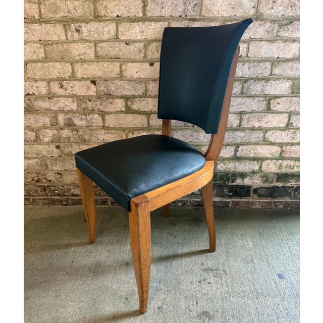 Set of Six (6) leather French Mid Century dining chairs, in the style of Andres Arbus. These art deco dining chairs are...