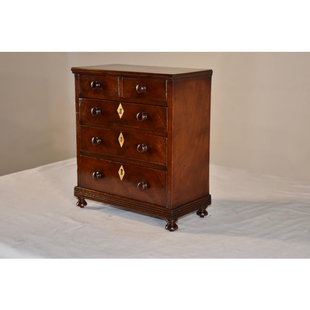 19th century miniature mahogany chest of drawers from England. This was most likely a very fine salesman's sample. In the...