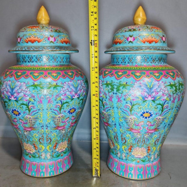 This is a striking and vibrant matching pair of large "General Jars" (Jiangjun Guan), crafted in the traditional Chinese...