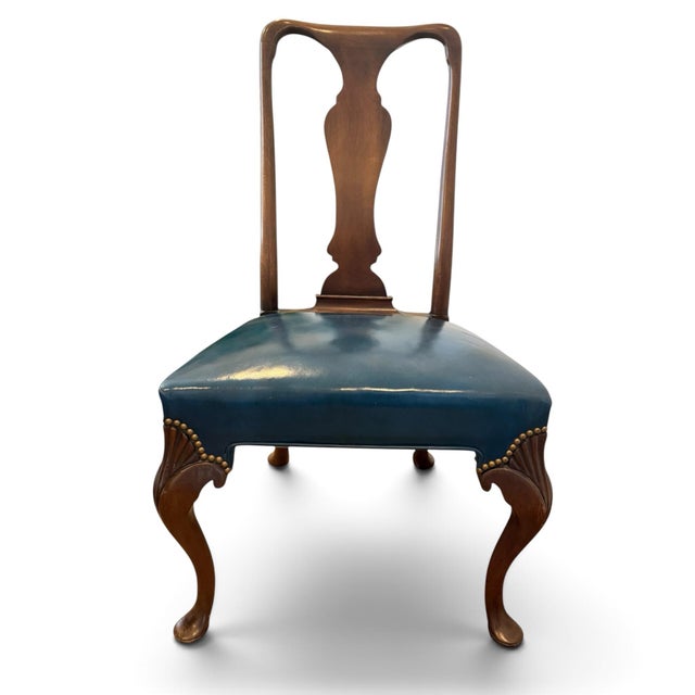 A set of eight dining chairs in the classic Queen Anne style. Solid mahogany with open figured backs, curved legs with...