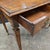 This Regency walnut and rosewood inlaid center table with 2 drawers, brass beading, ornate brass handles, and square...