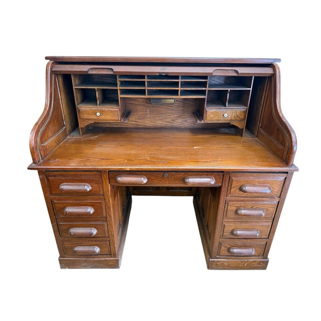 Solid wood desk by National Mt. Airy This vintage oak wood roll top desk is a blend of practicality and artistry, making...
