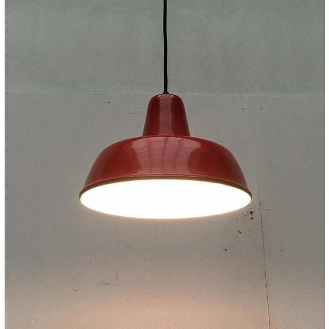Simple enamel pendant lamp in a special color. Functional pendulum in the classic form of an industrial or workshop lamp....