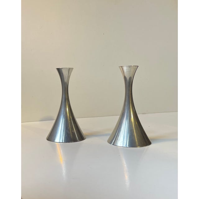 A pair of Trumpet Shaped Candlesticks designed by Arne Eskers and made by Just Andensen in Denmark during the 1950s. Both...