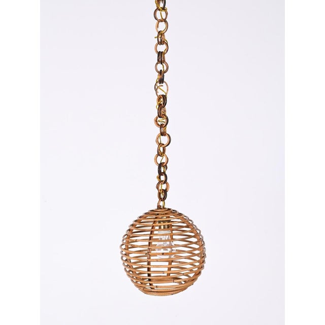 Stunning Mid-Century bamboo and rattan spherical chandelier in Cote d'Azur style. This wonderful item was produced in...
