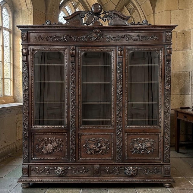 A monumental expression of the Renaissance Revival spirit, this impressive 19th century triple bookcase was masterfully...