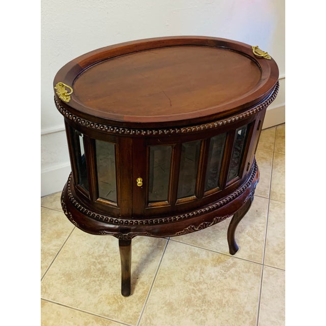 A beautifully crafted vintage mahogany oval bar cabinet that combines elegance, function, and timeless craftsmanship....