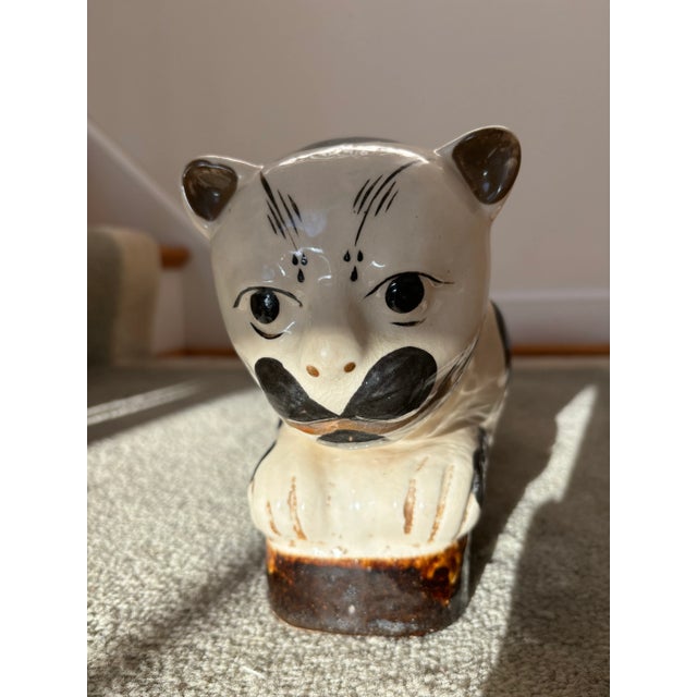 A Chinese soft paste porcelain Cizhou-ware Cat Pillow, probably late 19th century. These pillows were used by women to...