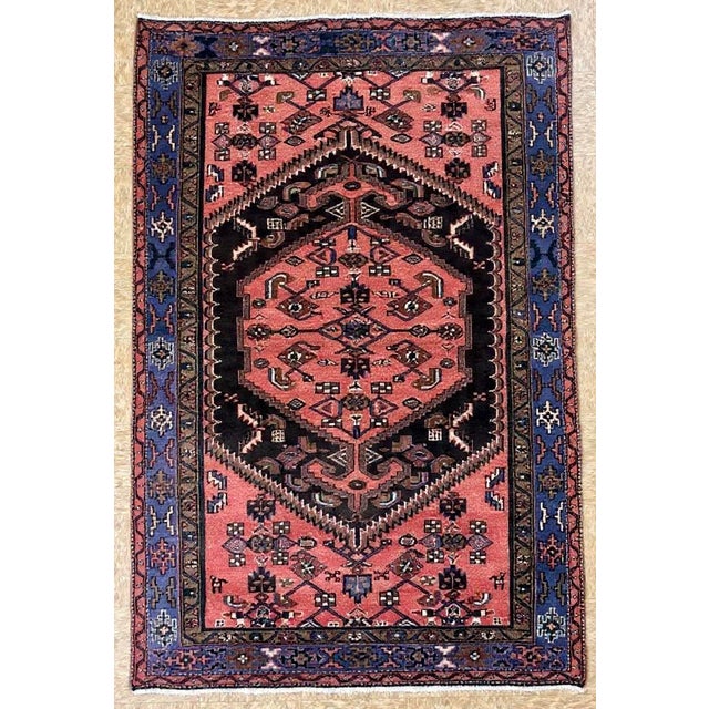 Antique hand-knotted rug from the Zanjan region in northwest Iran, featuring a large stepped central medallion set within...