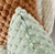 This decorative throw pillow features a soft, plush texture with a unique bubble-like pattern that adds a cozy and stylish...