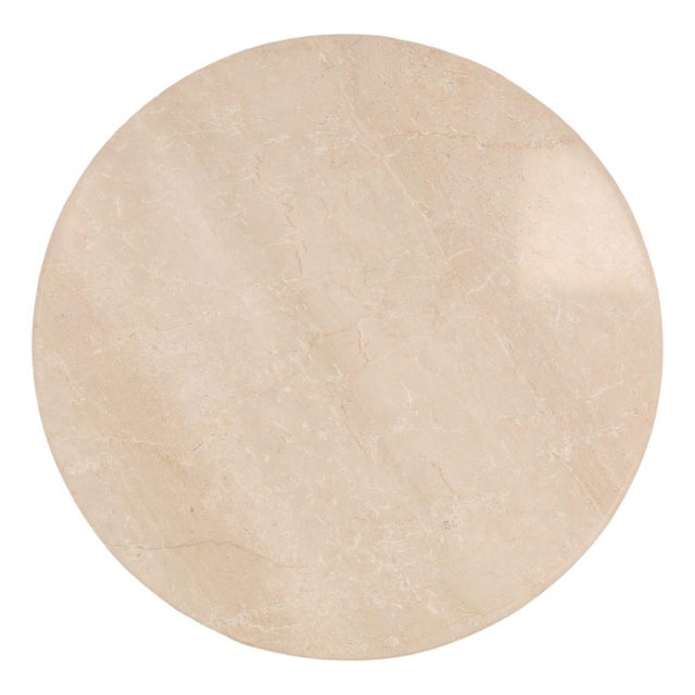 Round coffee table featuring a light Botticino stone top resting on a striking base of vertically arranged washed mango...