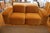 A four-piece modular sofa from Sarah Ellison's "Muse" collection for Ellison Studios, upholstered in warm cognac velvet....