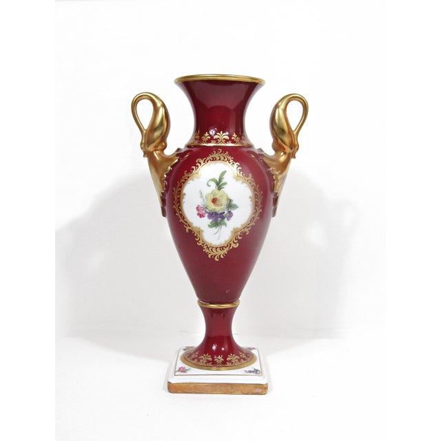 A wonderfully elegant Kaiser Comtesse porcelain vase from West Germany, styled with a deep burgundy ground, delicately...