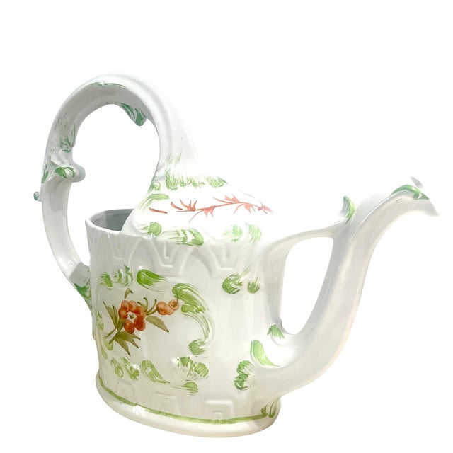 Add a vintage touch to your room decor with lovely ceramic watering can with hand-painted floral motifs. The hand-painted...