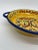 Colorful handled dish with an Italian design painted in the center. The bright yellows, blues, reds and greens make this a...