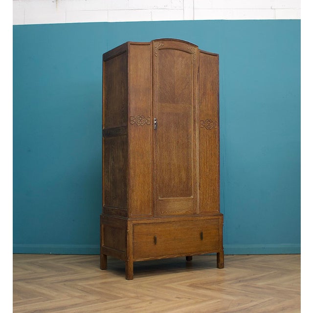 An oak hall cupboard dating to the late 1920s / early 1930s, finished in a light limed oak that highlights the natural...