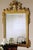 Handcrafted in Italy, this wall mirror features a solid beechwood frame with hand-carved details and a decorative crest....