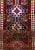 Beautiful vintage Turkish Hand-knotted wool runner with a ruby-red field. This rug has multi-color accents in an all-over...
